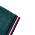 Polo Tommy Hilfiger de secado rápido con protección UV y ribete de rayas para hombre